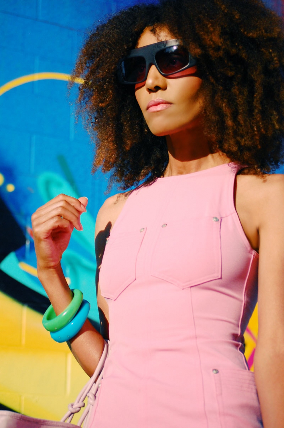 Ndoema sports a pink Versace dress, Phillip Lim sunglasses, Paola Graglia Bag and Report Signature floral high heel shoes