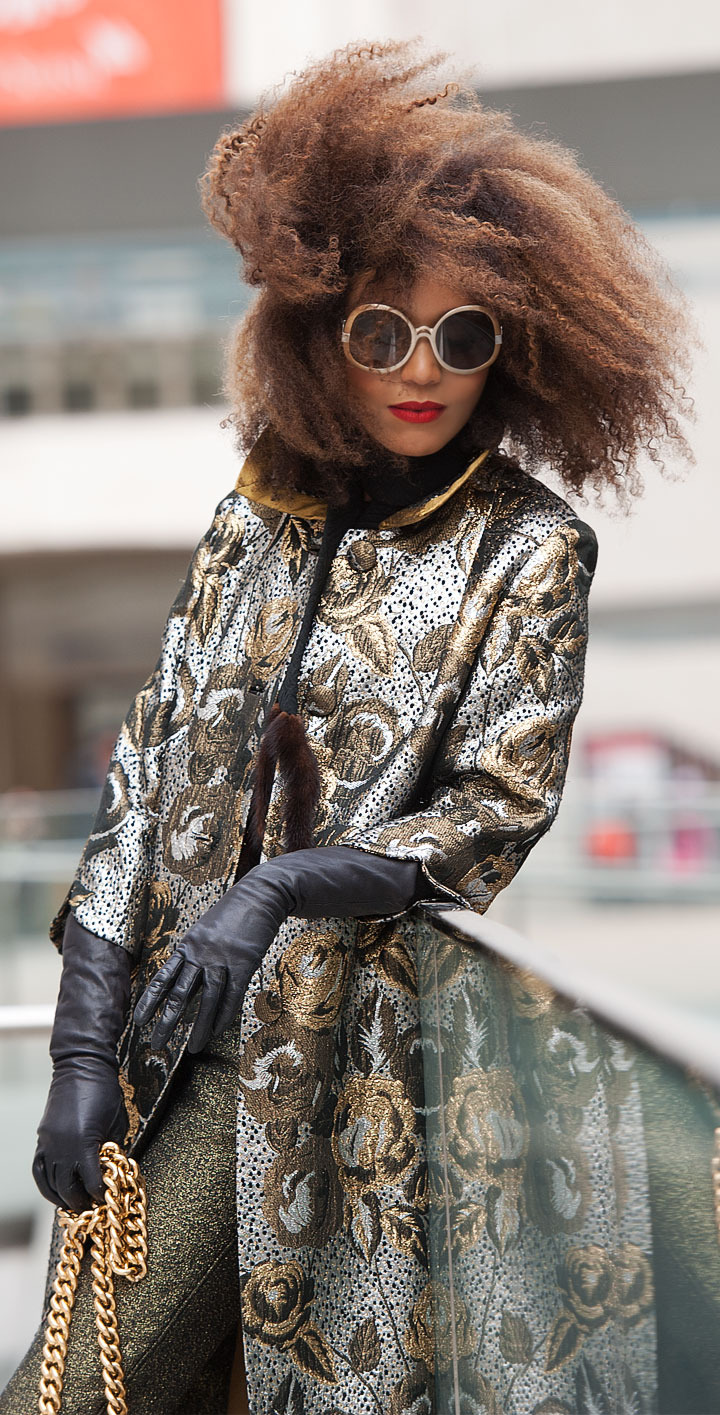 The Global Girl: Ndoema stars in a fashion editorial photographed by Paris-based photographer Kamel Lahmadi of Style and the City. Ndoema wears sunglasses by The Guise Archives, vintage silver and gold brocade coat, vintage gold chain and patent leather purse, Betsey Johnson gold glitter platform pumps, vintage black leather gloves, H&M gold metallic pants and vintage wool and fur scarf.