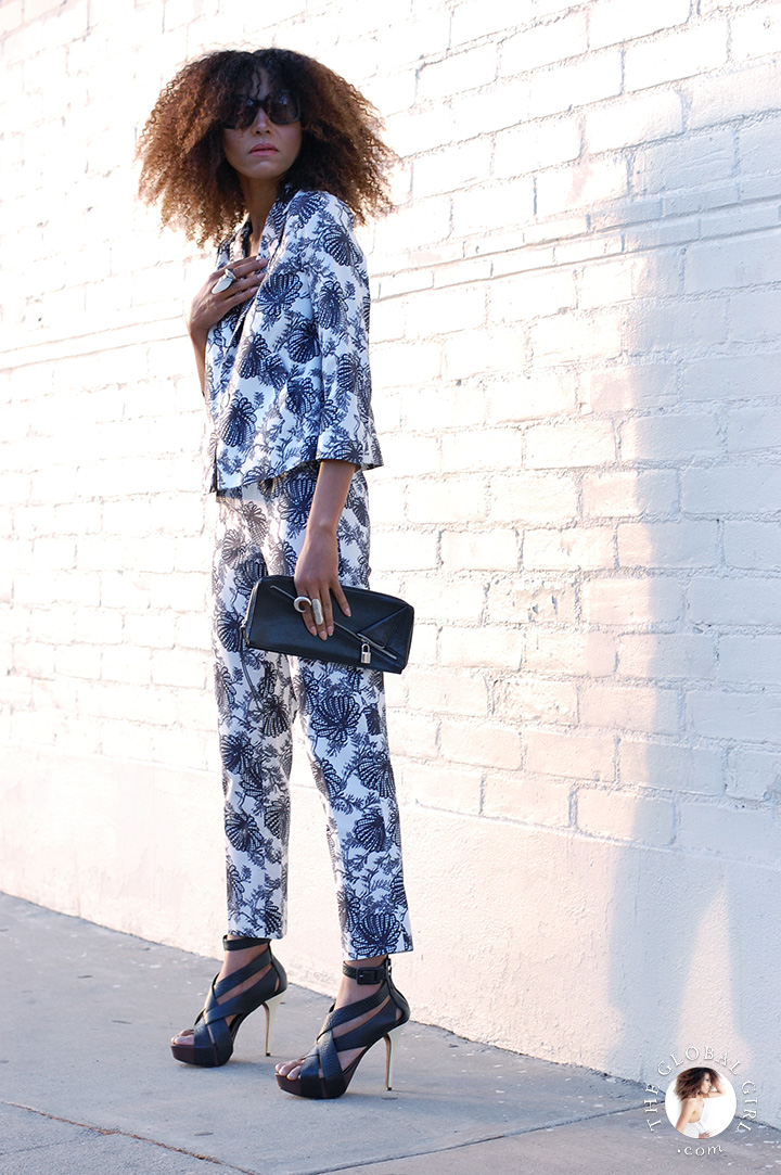 The Global Girl Daily Style: Ndoema rocks a graphic black and white, head-to-toe floral print pants and jacket ensemble with Karen Millen leather clutch, gladiator platform stiletto sandals by BCBG Max Azria, lace bralette and oversized sunglasses by Chloé.