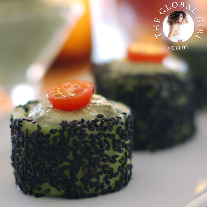 Cucumber rolls with raw vegan herbed cashew cheese and black sesame seeds. This healthy snack is raw, vegan, dairy free and gluten free.
