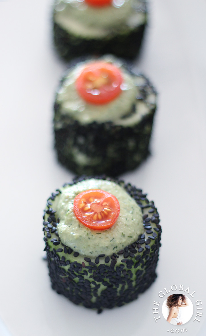 Cucumber rolls with raw vegan herbed cashew cheese and black sesame seeds. This healthy snack is raw, vegan, dairy free and gluten free.