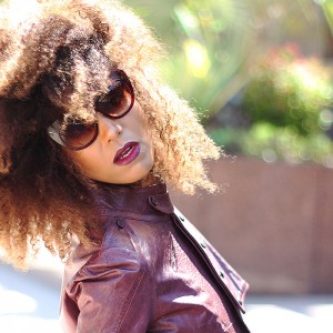 Ndoema is rocking a cropped leather jacket by Diesel , Tom Ford lip color in bruised plum and House of Harlow 1960 Chelsea Cateye Sunglasses