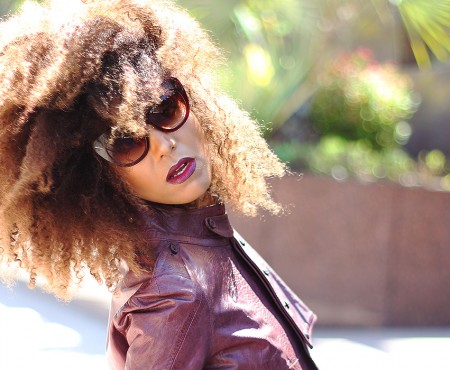 Ndoema is rocking a cropped leather jacket by Diesel , Tom Ford lip color in bruised plum and House of Harlow 1960 Chelsea Cateye Sunglasses