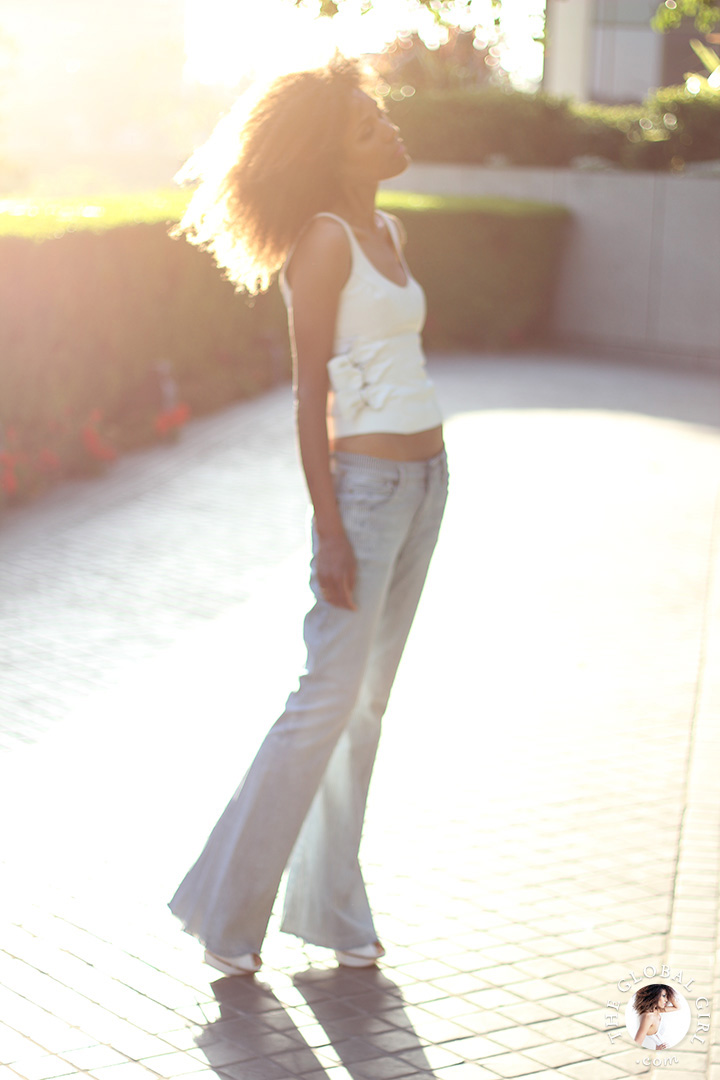 Ndoema rocks the midriff look in low rise flare jeans by J Brand and a vintage leather cropped top.