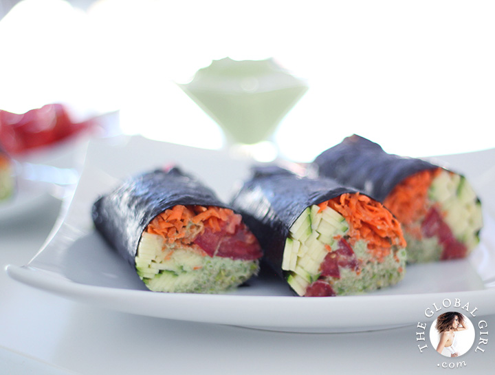 Raw vegan nori rolls with creamy cilantro sauce, shredded carrots, zucchini, tomatoes and clover sprouts. 100% gluten free, dairy free and oil free.