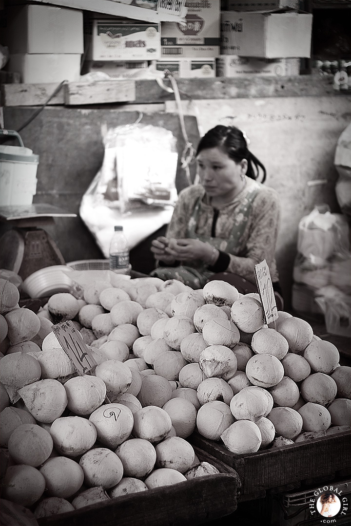 The Global Girl Travels: Coconut merchant at Khlong Toey market in Bangkok, Thailand.