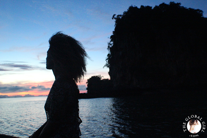 The Global Girl Travels: Ndoema takes in the sunrise on a traditional thai long boat in the Andaman Sea.