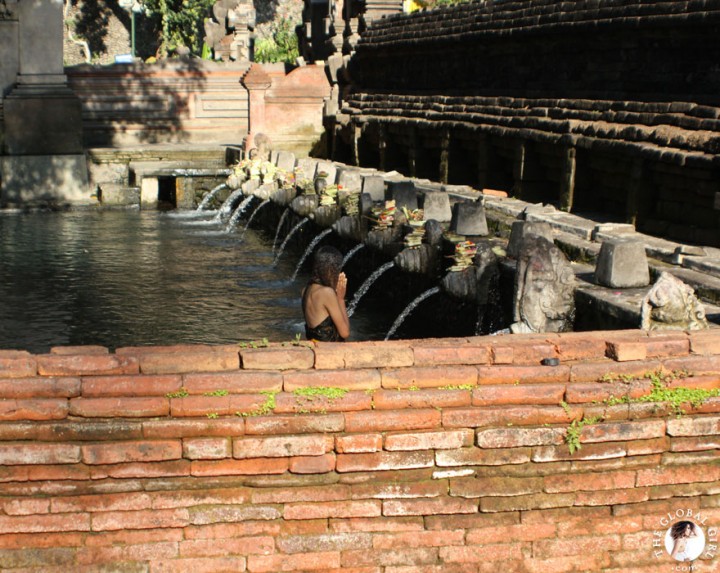 The Global Girl Travels: Ndoema bathing in holy spring water at the Tirta Empul Temple in Bali, Indonesia.