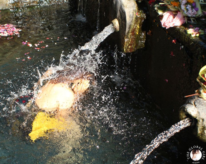 The Global Girl Travels: Ndoema bathing in holy spring water at the Tirta Empul Temple in Bali, Indonesia.