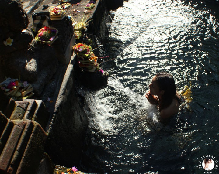 The Global Girl Travels: Ndoema bathing in holy spring water at the Tirta Empul Temple in Bali, Indonesia.