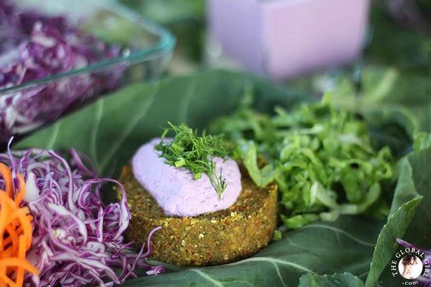 The Global Girl Raw Food Recipes: Carrot & Dill Burgers in collard green leaf with shredded red cabbage, romaine lettuce, carrots and red onion. 100% raw, vegan and gluten-free.