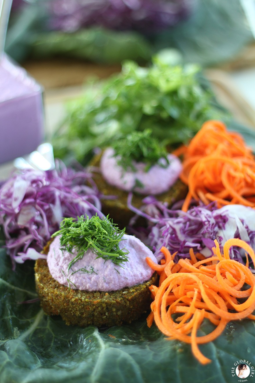 The Global Girl Raw Food Recipes: Carrot & Dill Burgers in collard green leaf with shredded red cabbage, romaine lettuce, carrots and red onion. 100% raw, vegan and gluten-free.