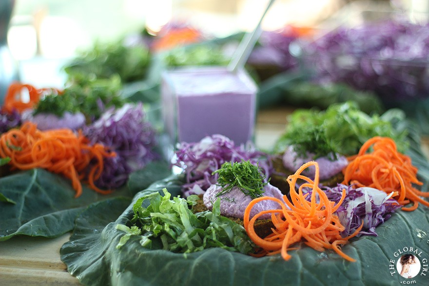 The Global Girl Raw Food Recipes: Carrot & Dill Burgers in collard green leaf with shredded red cabbage, romaine lettuce, carrots and red onion. 100% raw, vegan and gluten-free.