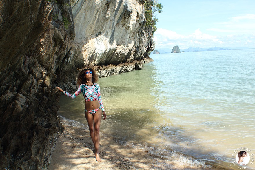 The Global Girl Travels: Picture perfect private island in the Phang Nga Bay off Koh Yao Noi, Thailand. Ndoema sports a geometric-print rashguard and bikini set with cat eye mirrored sunglasses.