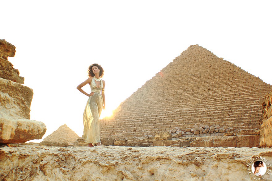 The Global Girl Travels: Ndoema in a goddess gold lame gown by Vicky Tiel at the Giza Pyramids in Egypt.