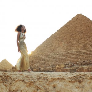 The Global Girl Travels: Ndoema in a goddess gold lame gown by Vicky Tiel at the Giza Pyramids in Egypt.