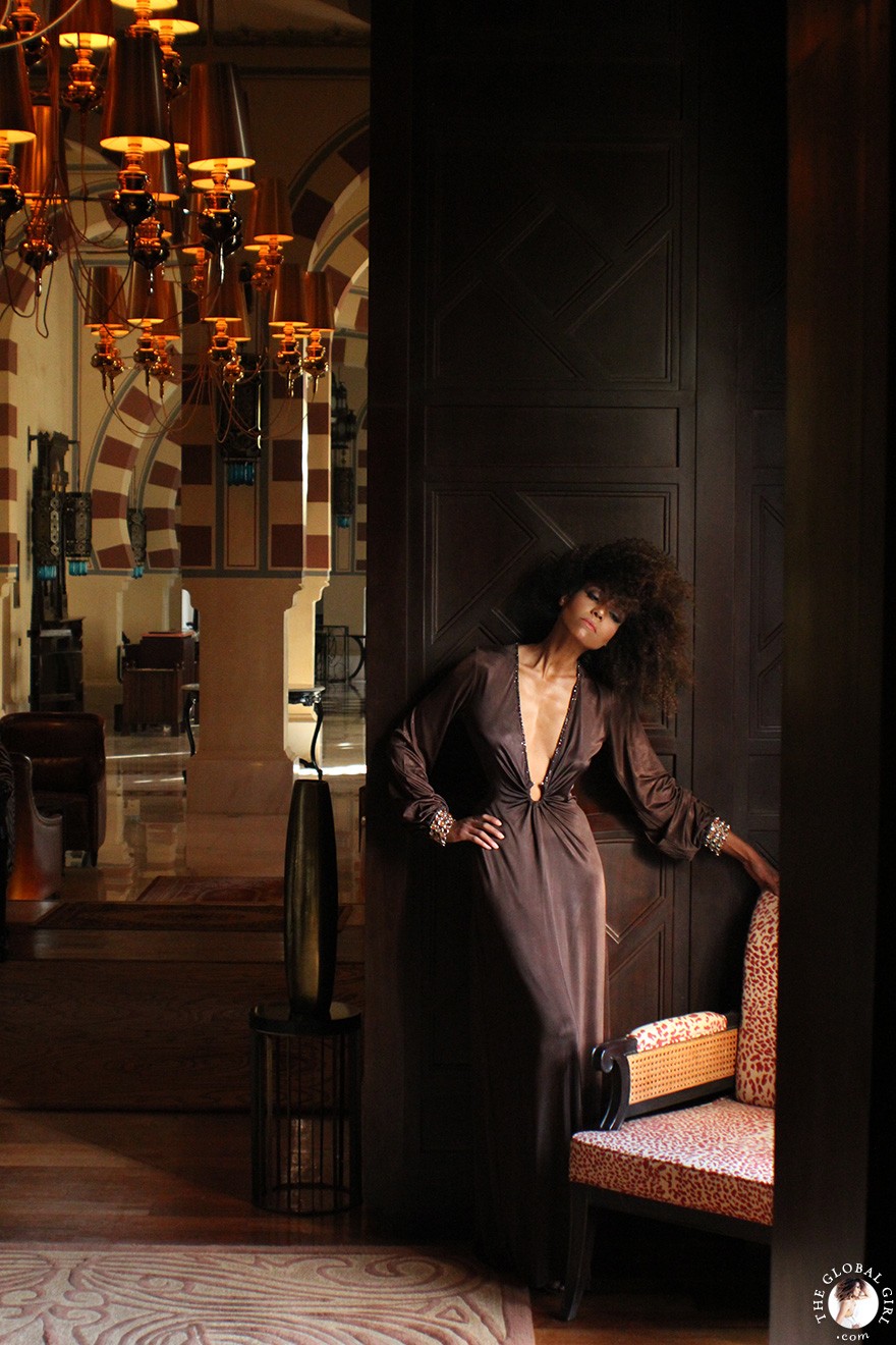 The Global Girl Fashion Editorials: Ndoema channels neo-aristocratic chic in a vintage chocolate brown gown with deep v plunging neckline and custom three-row topaz link bracelets at the Sofitel Legend Old Cataract hotel in Aswan, Egypt.