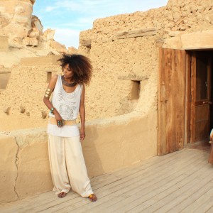 The Global Girl Daily Style: Ndoema channels boho chic style in ethnic-inspired beaded tank by Antik Batik, silk palazzo pants by Robert Rodriguez, jeweled sandals by Miu Miu and her own collection of tribal jewelry. Photographed at the Adrère Amelia luxury eco-friendly desert resort at Siwa Oasis, Egypt.