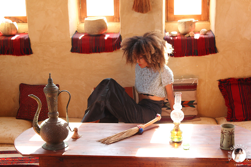 The Global Girl Travels: Ndoema at Talist, a Berber-style luxury and eco-friendly resort at Siwa Oasis, Egypt. Ndoema sports a high-waist maxi skirt by Vivienne Westwood with a vintage embellished cropped top and jeweled stiletto heels.