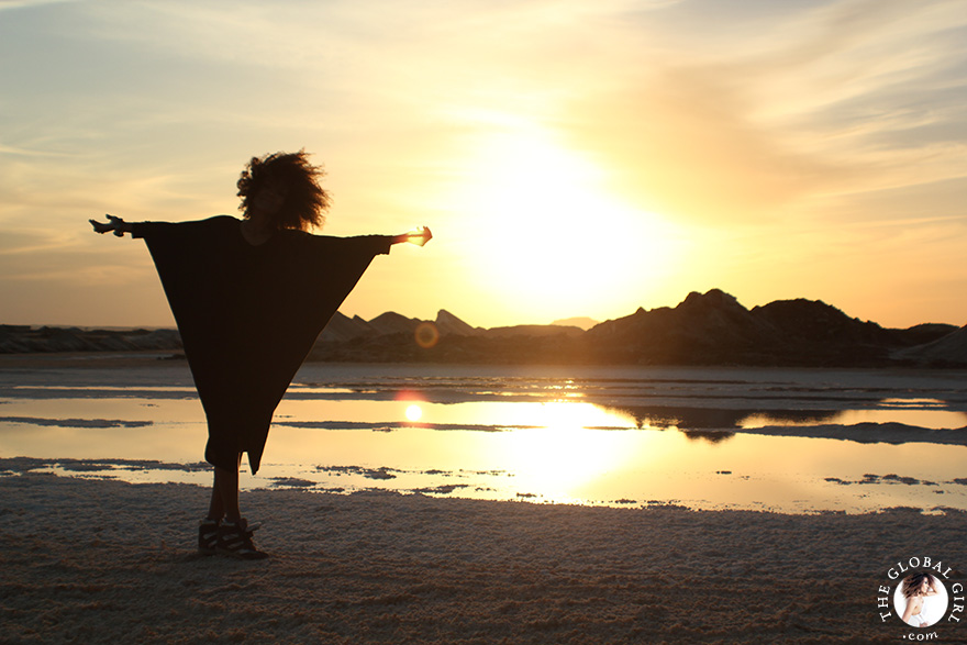 The Global Girl Travels: Ndoema at a local salt mine against the blazing North African sunset, at Siwa Oasis, Egypt.