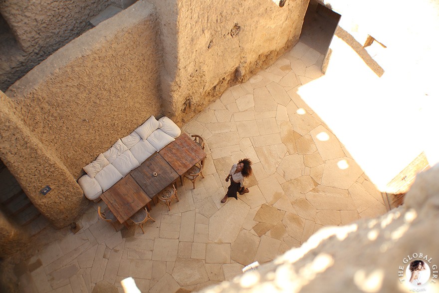 The Global Girl Travels: Ndoema goes monochromatic in earth toned tribal harem pants, safari shirt and ankle tie sandals at the Al-Babinshal Heritage hotel in Siwa, Egypt.