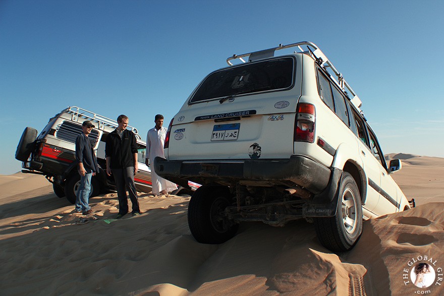 The Global Girl Travels: Four-wheel drive land cruiser stuck on a sand dune in the Libyan desert on a safari in the sahara, North Africa.