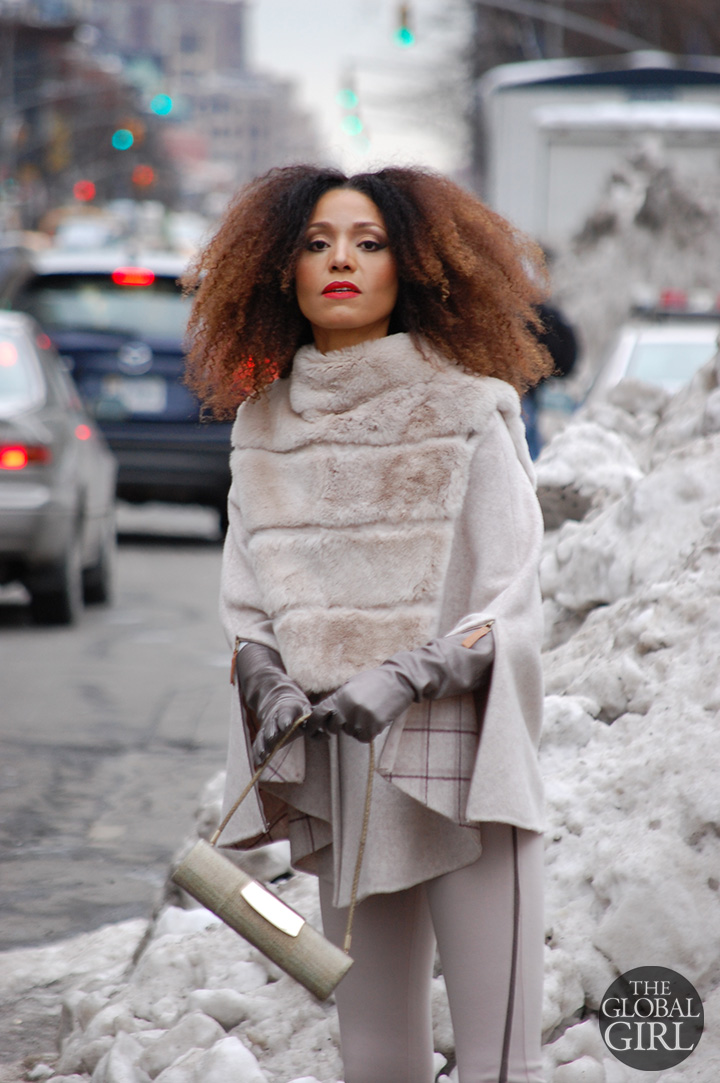 The Global Girl Style: Ndoema rocks the winter cape look in a beige Son Jung Wan cape and flare pants ensemble with Sergio Rossi bag during New York Fashion Week Fall 2014.