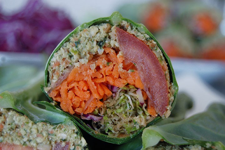 The Global Girl Raw Vegan Recipes: Falafel Burger Wrap in a collard creen Leaf with carrot, sprouts, tomato, red cabbage and red onion.