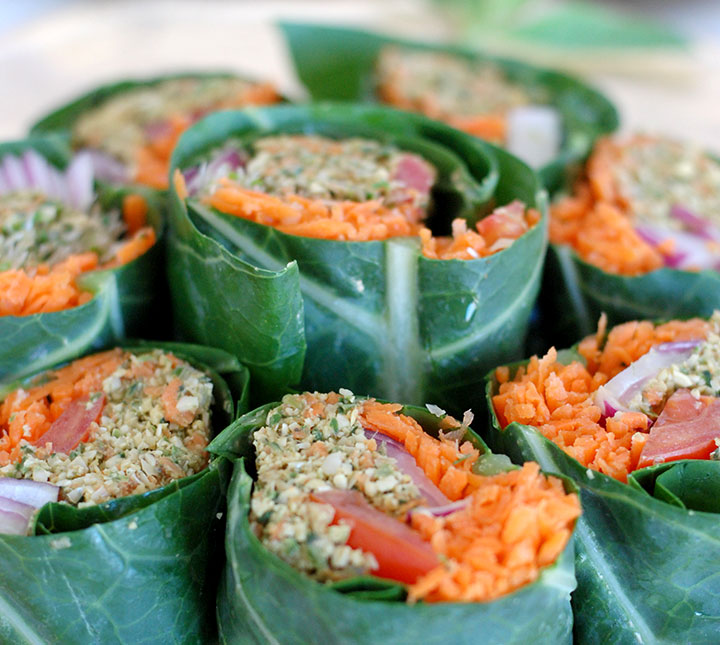 The Global Girl Raw Food Recipes: Raw Wrap with Pumpkin Seed & Mint Patty in a collard green leaf with tomato, shredded carrot, red onion and clover sprouts.