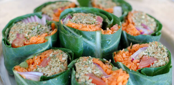 The Global Girl Raw Vegan Recipes: Veggie Wrap with Pumpkin Seed & Mint Patty in a collard green leaf with tomato, shredded carrot, red onion and sprouts.