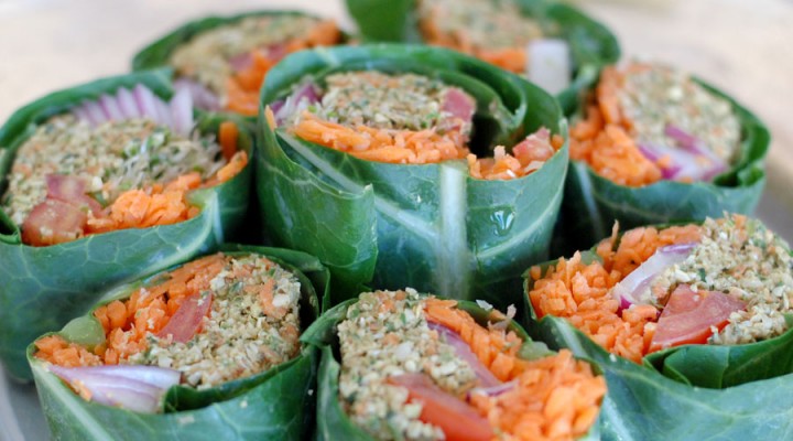 The Global Girl Raw Vegan Recipes: Veggie Wrap with Pumpkin Seed & Mint Patty in a collard green leaf with tomato, shredded carrot, red onion and sprouts.